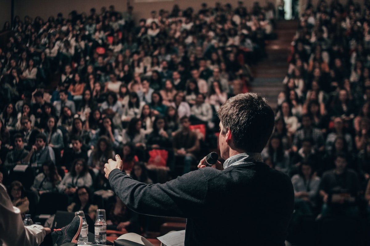 A speaker addressing a large auditorium during a presentation skills session