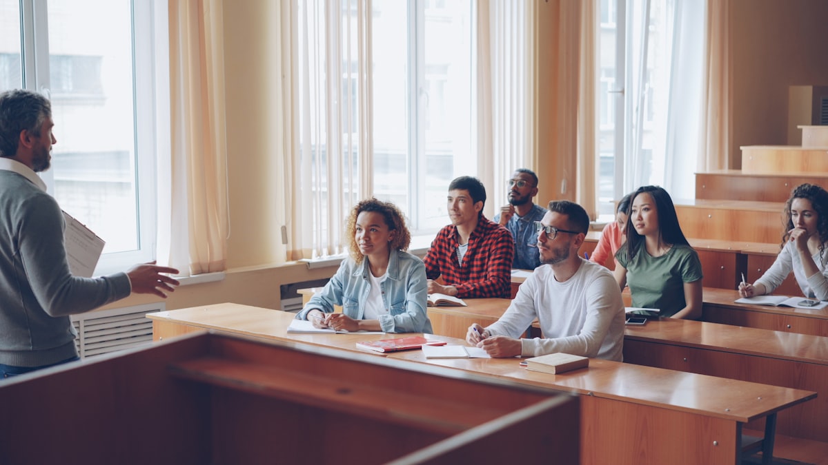 A lecturer addressing a diverse group of students in a university classroom